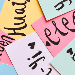 A pile of postit notes with names on them